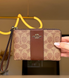 Гаманець-клатч Coach коричневий лого CW854 IMXHE фото